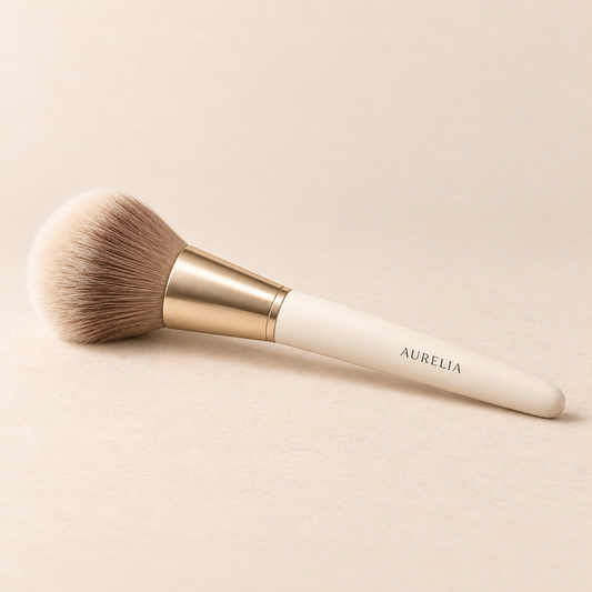 Aurelia Botanicals Makeup Brush on a warm beige background.